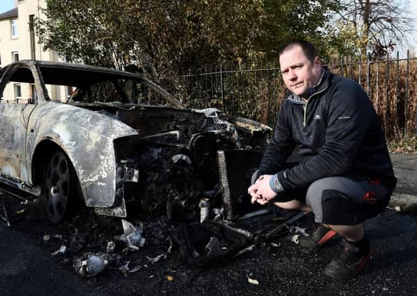 Alistair Clark with his Audi that was set alight during the Bonfire Night rampage. Picture: Lisa Ferguson