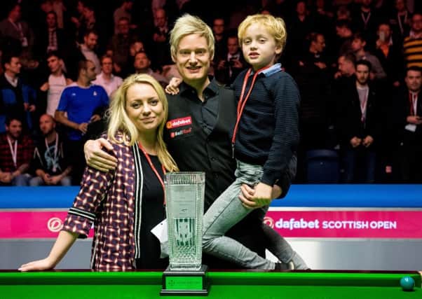 Neil Robertson (centre) is pictured with his partner Mille Fjelldal and his son Alexander as he claims The Stephen Hendry trophy