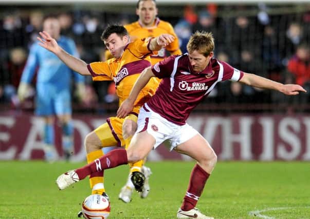 Hearts captain Michael Stewart tussles with Steve Jennings