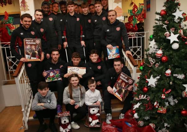 Hearts players at the Sick Kids Hospital Edinburgh deliver presents.