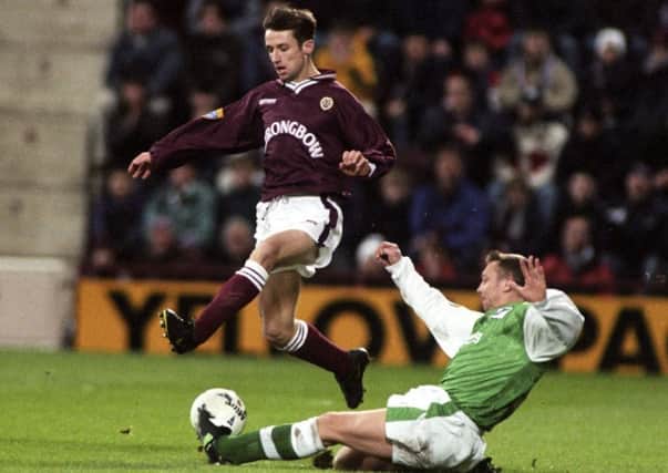 Hearts winger Neil McCann is challenged by Hibs defender Willie Miller at Tynecastle on New Year's Day 1998