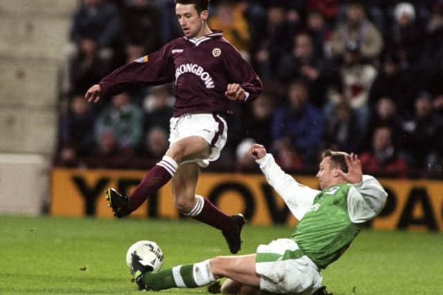 Hearts winger Neil McCann is challenged by Hibs defender Willie Miller at Tynecastle on New Year's Day 1998