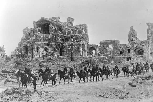 22nd August 1918:  The British Cavalry passing the remains of Albert Cathedral, after the 2nd Battle of the Somme. Getty Images