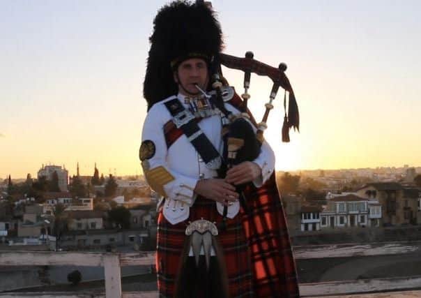 A piper of the Scots Dragoon Guards playing his instrument in Cyprus. Picture TSPL