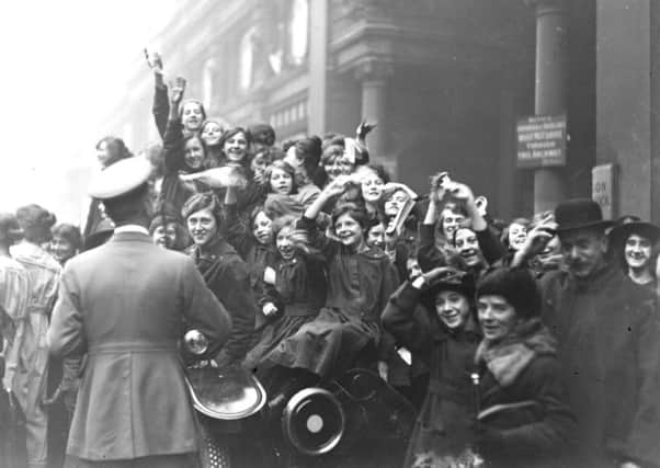 11th November 1918:  Crowds celebrating the armistice in London, at the end of World War I.  Getty Images