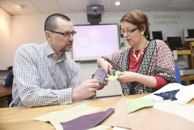 Edinburgh Remakery upcycling shop opens on Leith Walk with Helen Stephenson who takes leather workshops and makes things like phone cases from recycled bits of leather showing Iain Gulland Chief Executive of Zero Waste Scotland how to do it