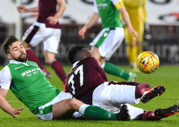 Hearts striker Esmael Goncalves is challenged by Hibs defender Darren McGregor
