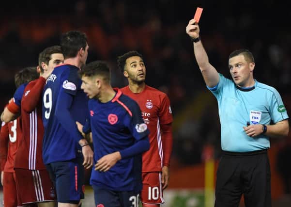 Referee John Beaton shows the red card to Kyle Lafferty at Pittodrie following the strikers challenge on Graeme Shinnie