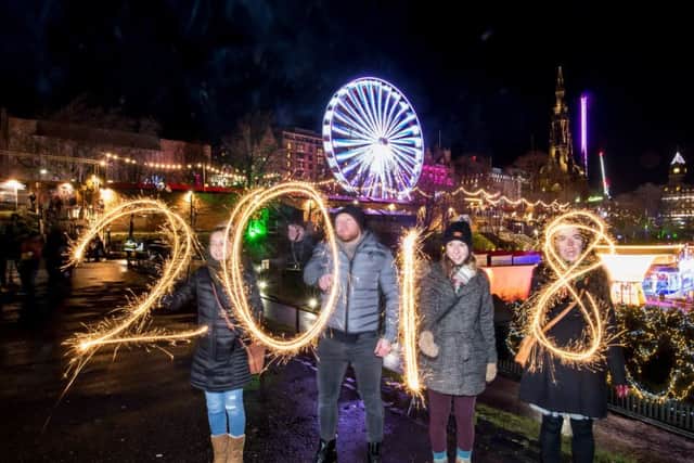 Jenni Mitchell and Jonathan Lee, both from Newcastle joined Hillary Smith from Sequim, WA, USA and Una Taylor from Peebles to make a sparkly 2018

. Picture: Wullie Marr