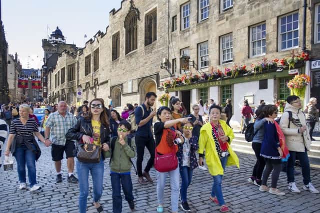 A tourist tax has been backed by a former council leader. Tourists on the Royal Mile/High Street, Edinburgh during the 2017 Edinburgh International Festival.