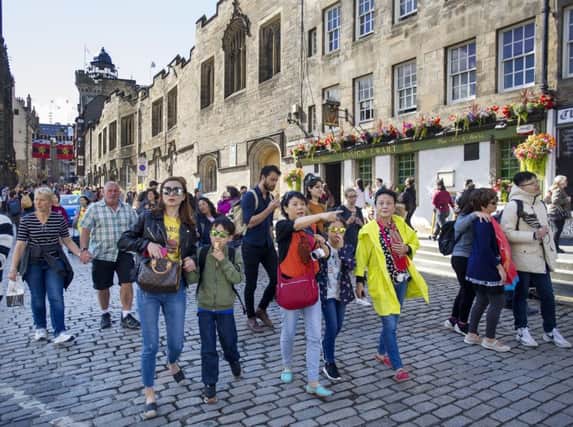 A tourist tax has been backed by a former council leader. Tourists on the Royal Mile/High Street, Edinburgh during the 2017 Edinburgh International Festival.