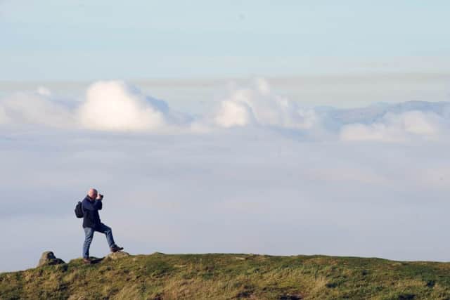 A walker enjoys the view as he looks out over the Forth valley from Cockleroy Hill. Picture: Ian Rutherford