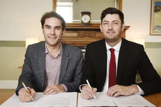 SNP Group leader Adam McVey and his Labour counterpart, Cammy Day, sign the city council coalition deal. Picture: PA