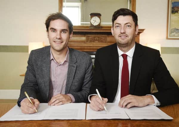 SNP Group leader Adam McVey and his Labour counterpart, Cammy Day, sign the city council coalition deal. Picture: PA