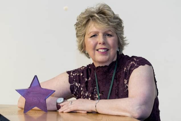 Kim Roward with the Purple Star award