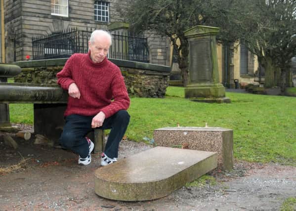 Bert Hutchings, Greyfriar's Kirk and Kirkyard guide, with the vandalised grave stone. Picture: Ian Georgeson