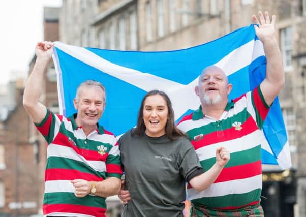 Welsh fans Les Griffiths and Peter Price with Biddy Mulligans Bar staff member Antonia Chaytor in the Grassmarket ahead of the Scotland-Wales Six Nations match at Murrayfield. Picture: Ian Georgeson