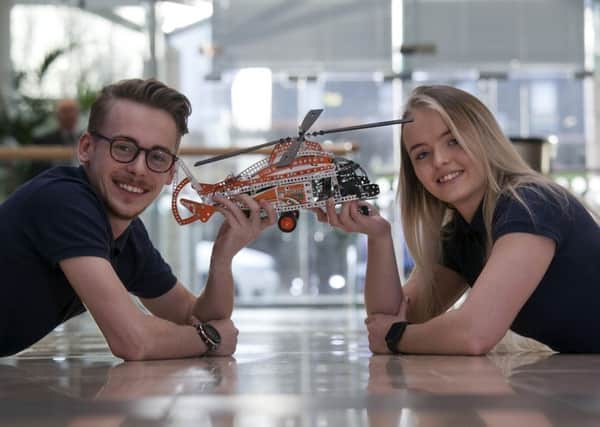 Thomas Sutherland and Emily Martin with a model  helicopter, designed as part of a new work placement scheme at Leonardo MW in Edinburgh. Photograph: Alistair Linford
