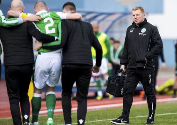 A concerned Neil Lennon looks on as David Gray is helped off against Willem II
