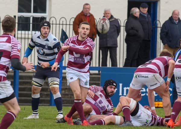 Ali Harris spins a pass out for Watsonians. Pic: Ian Georgeson