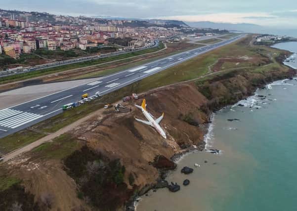 A Pegasus Airlines Boing 737 passenger plane is seen struck in mud on an embankment, a day after skidding off the airstrip. Picture: OUTSTRINGER/AFP/Getty Images