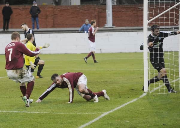 Colin Strickland slides in to score the second for Linlithgow. Pic: Greg Macvean