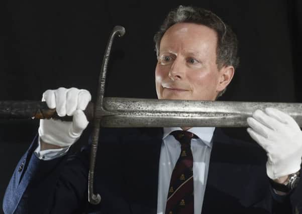 Lord Charles Bruce poses with Robert the Bruce's broadsword