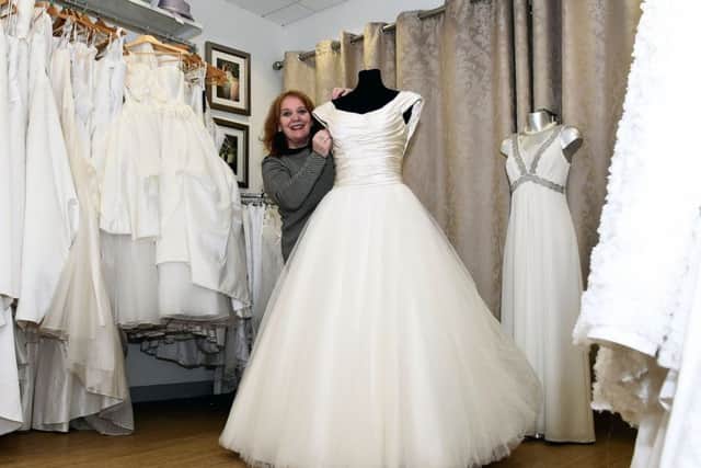 Shop manager Rosa Rosado with a dress worth £14,000. Picture: Lisa Ferguson