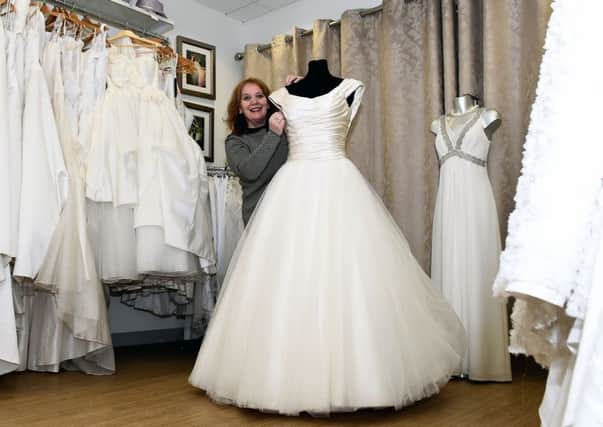 Shop manager Rosa Rosado with a dress worth Â£14,000. Picture: Lisa Ferguson