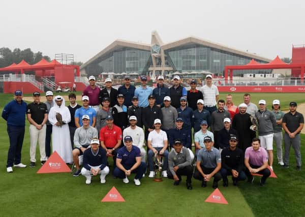 Tom Buchanan, middle row fourth from the right, lines up ahead of the Abu Dhabi HSBC Championship