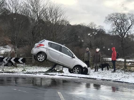 A car skidded on Hermitage Drive and ended up on top of a road sign. Picture: Shaun Donaldson (@Shaun_Donaldson)