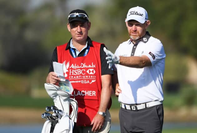 Stephen Gallacher talks through a shot with his new caddie, fellow Scot John Dempster, in the first round of the Abu Dhabi HSBC Championship. Picture: Getty Images
