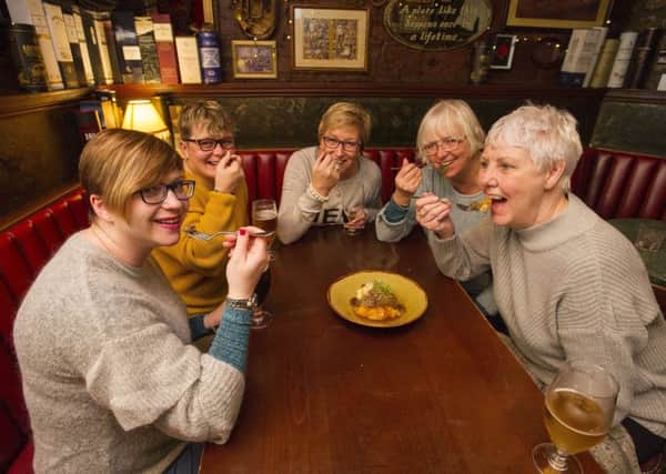 A group of women from Harrogate in Yorkshire taste haggis for the first time in Dirty Dick's pub in Rose Street during a visit to Edinburgh to see Miss Saigon. Picture: Ian Rutherford