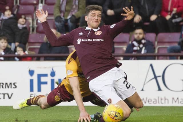 Ross Callachan tumbles under the challenge of Motherwell's Tom Aldred
