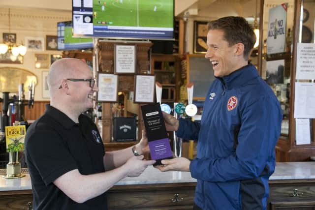 BT Manager of the month - Kevin McGee, landlord of the Athletic Arms, being presented with the award by Hearts captain Christophe Berra