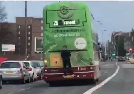 The young lad on the back of a No.26 bus.