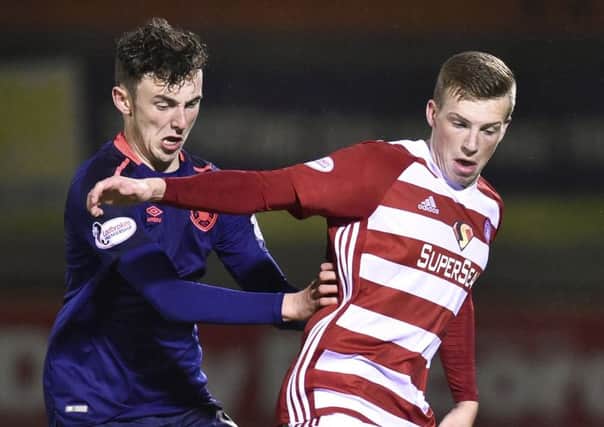 Andy Irving puts pressure on Hamiltons Lewis Ferguson during his Hearts debut