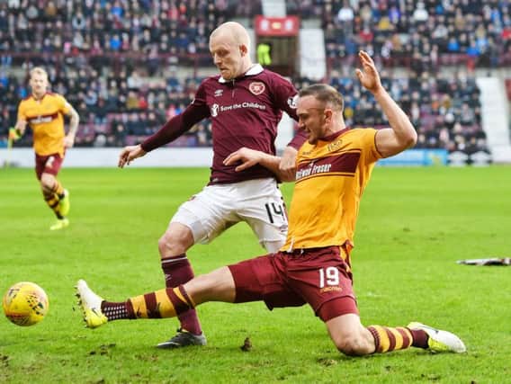 Steven Naismith callenges Tom Aldred of Motherwell at Tynecastle