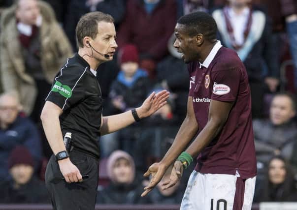 Hearts midfielder Arnaud Djoum remonstrates with referee Willie Collum