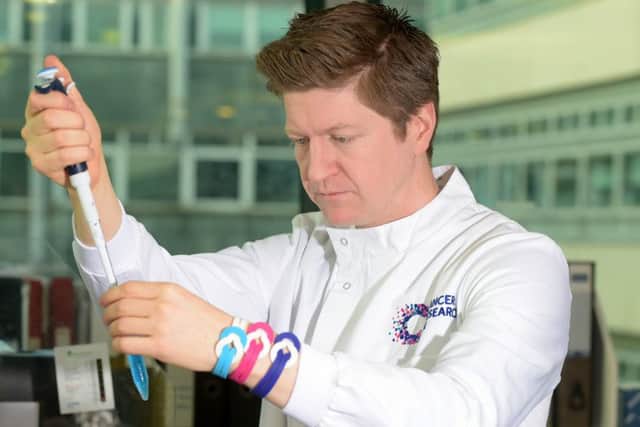 Dr John Thomson from the Cancer Research UK Edinburgh Centre is encouraging people in the city to wear a Cancer Research UK Unity Band with pride on Sunday,