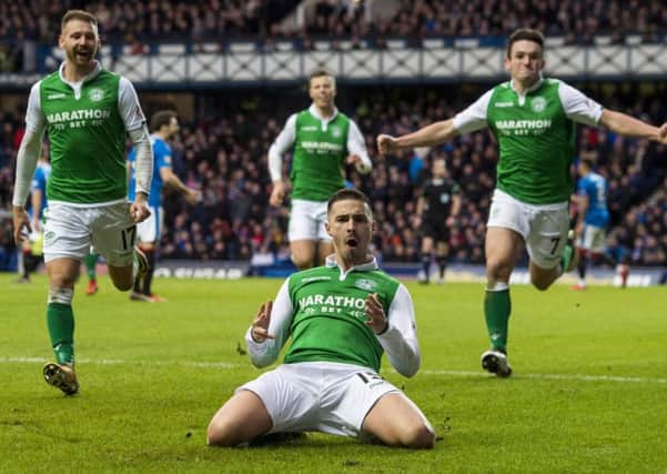 Jamie Maclaren celebrates after scoring the winning goal from the penalty spot