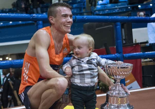Chris O'Hare holds his son Ronan along with his trophy in the Millrose Games track and field meet in New York. Photo: Craig Ruttle/AP