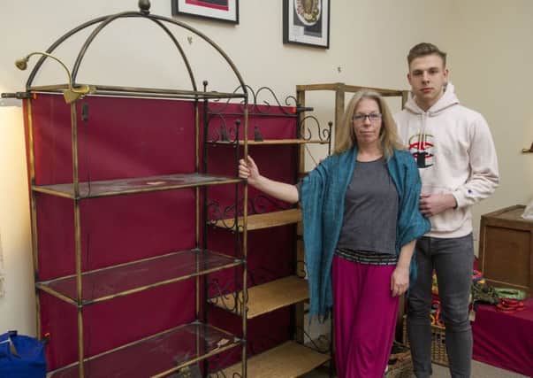 Janis Binnie with her son Chris Endres beside the shelves left empty by thieves in Santosa Yoga Cafe on Albert Street. Picture: Ian Rutherford