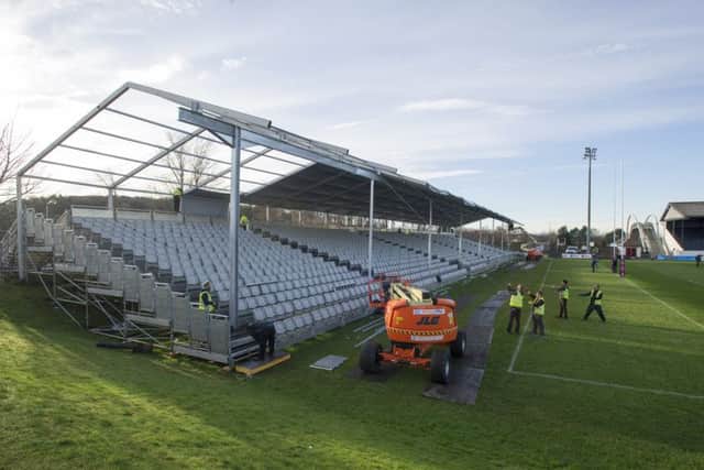 PREPARATIONS: Workmen erect temporary stands at Myreside