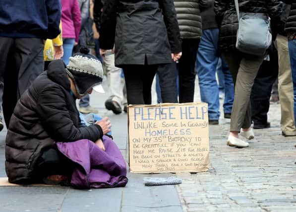 A 

homeless person sits on the Royal Mile. Picture: Lisa Ferguson
