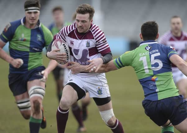 Rory Hutton of Watsonians bursts through to score a try. Pic: Neil Hanna