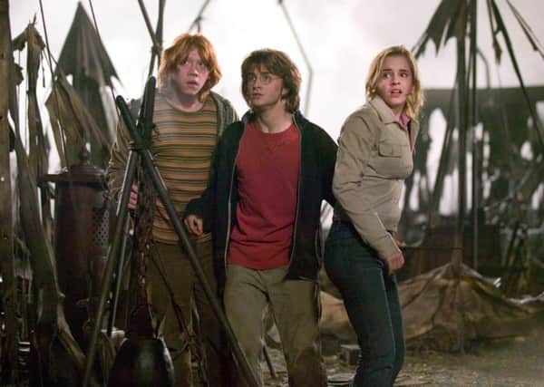 Rupert Grint as Ron, Daniel Radcliffe as Harry and Emma Watson as Hermione