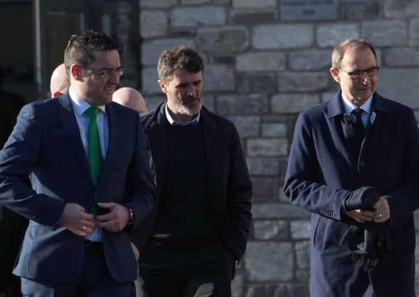 Roy Keane (centre) and Martin O'Neill (right) arrive for the funeral of former Hibs player Liam Miller at St. John the Baptist Church in Ovens, County Cork. Pic: PA