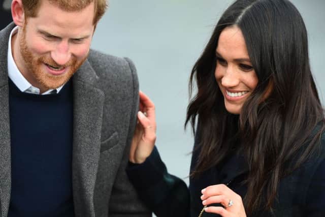 Prince Harry and his fiancÃ©e, US actress Meghan Markle smile during a walkabout on the Esplanade at Edinburgh Castle, during a visit to Scotland. Picture: AFP PHOTO / Andy BUCHANANANDY BUCHANAN/AFP/Getty Images