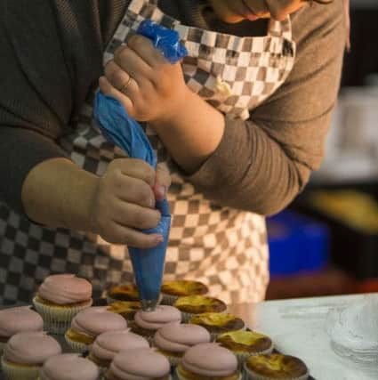 Assistant bakery manager Gulnasheen Shahid icing the cupcakes, Picture: SWNS